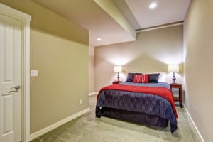 Basement guest bedroom with blue and red bed