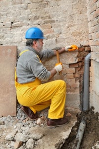 Man Working On Brick Wall