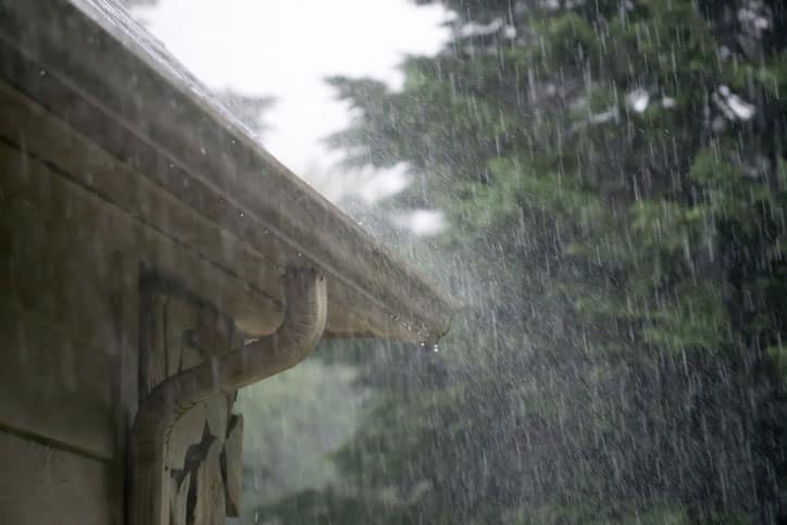 Down pour of rain on home gutters.