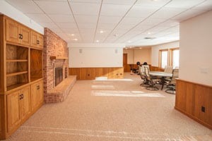 Spacious finished basement with white ceiling.