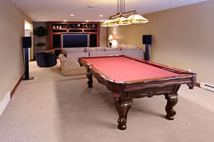 Finished basement with pool table.