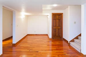Finished basement with wood floors.